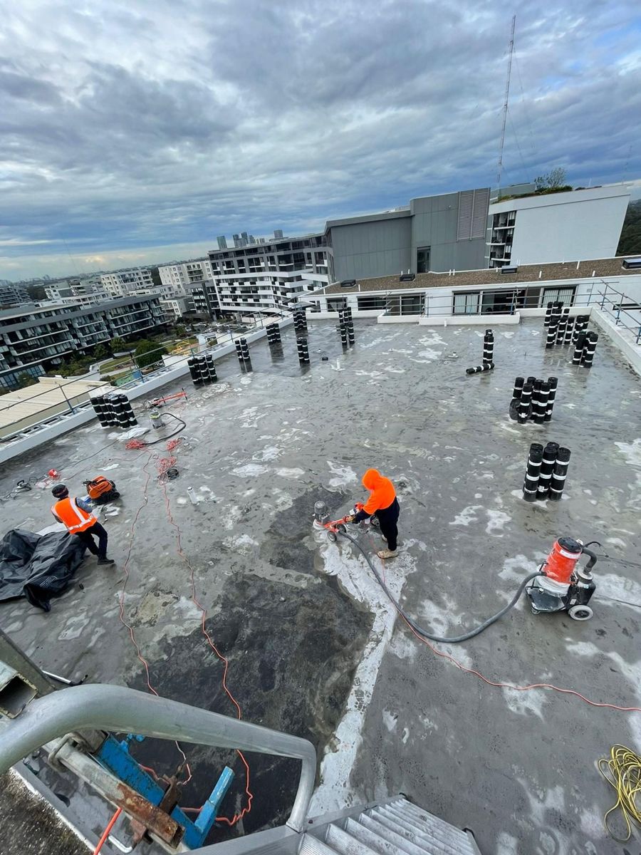 Crew installing torch-on membrane and plant upstands on the Stromboli Strait rooftop
