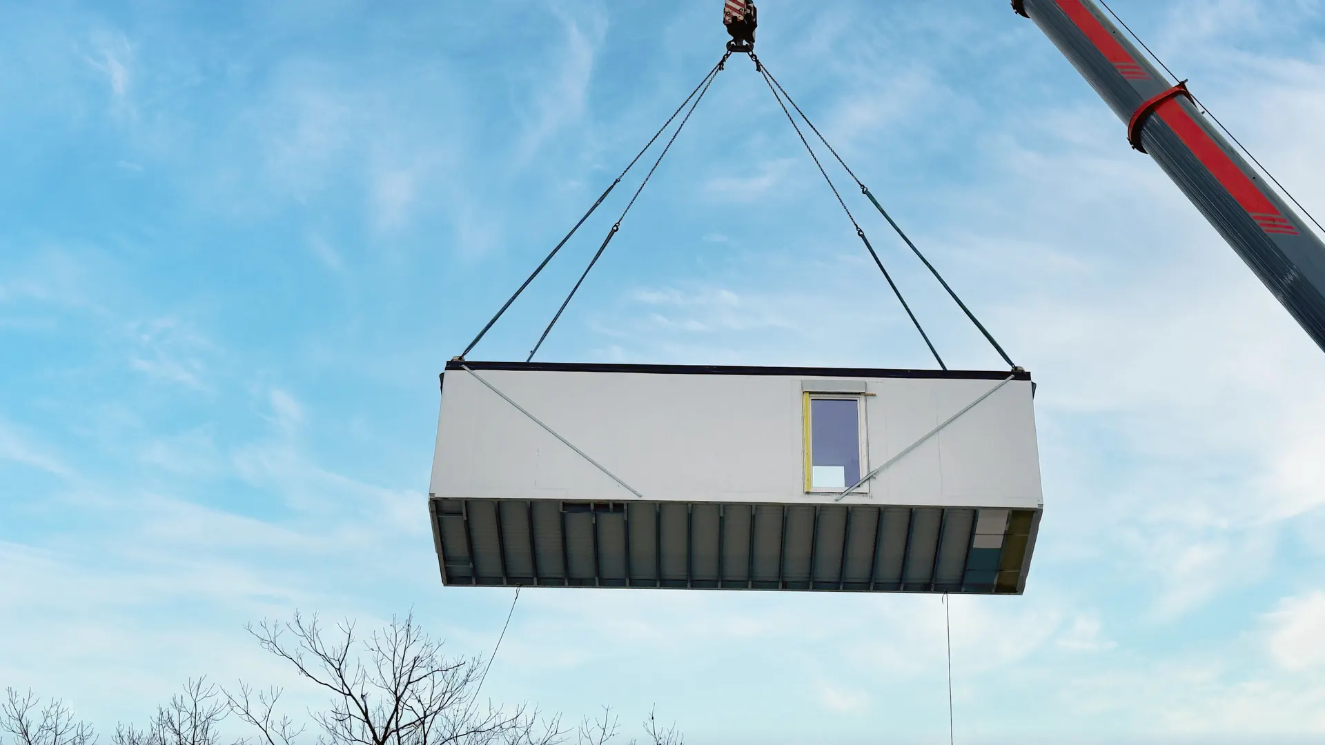 Crane lifting a prefabricated modular building unit into place