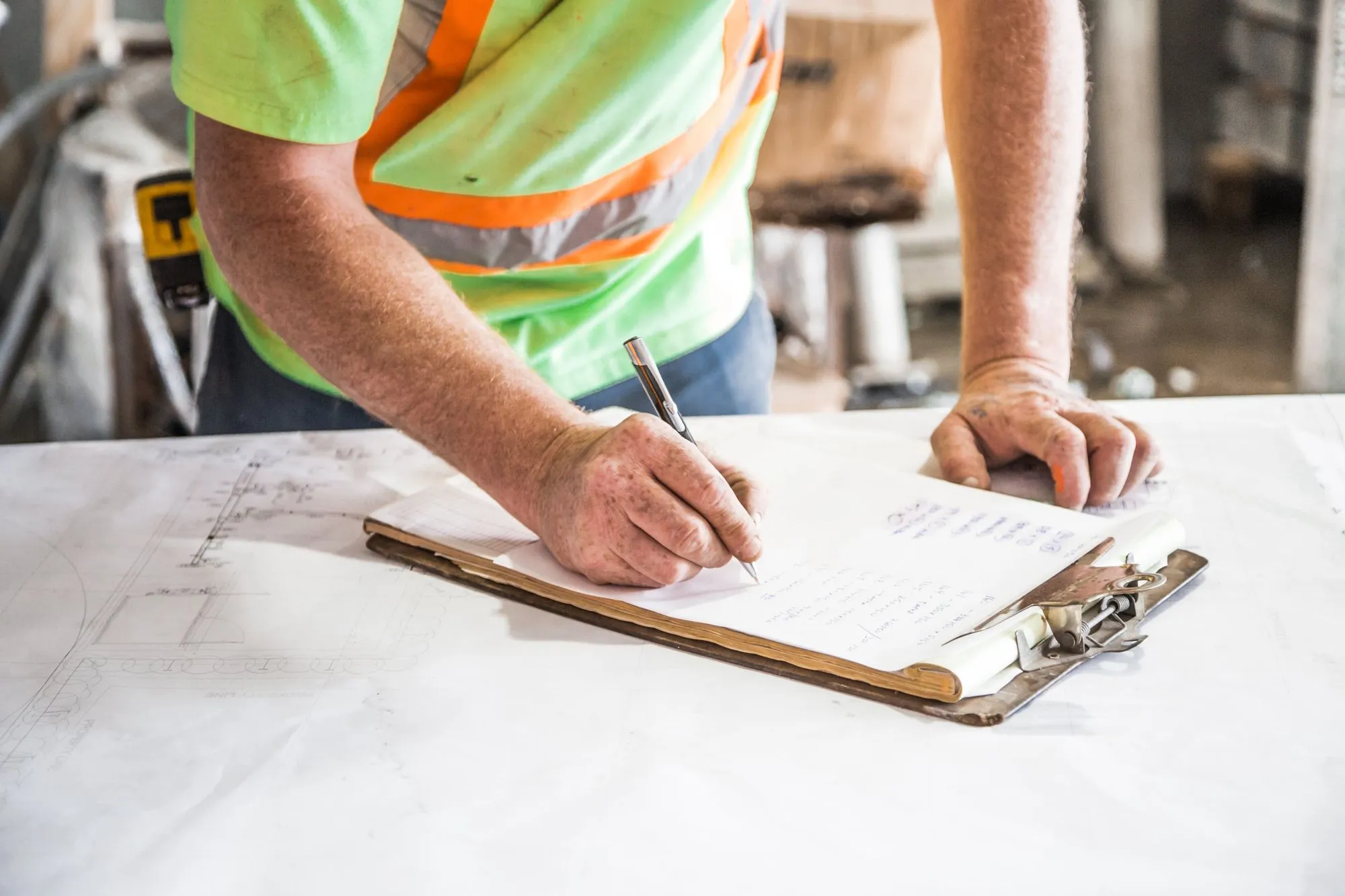 Project manager completing an approvals checklist on site
